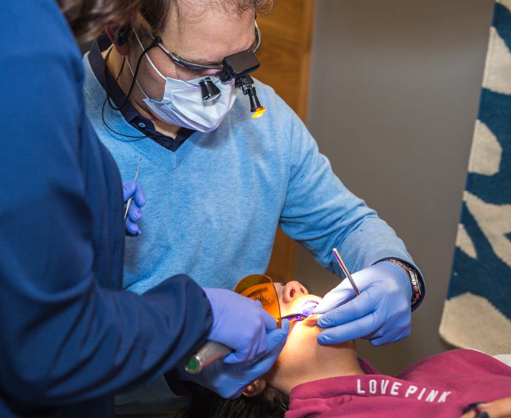 young man getting braces checked